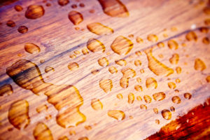 Rain droplets on a boat rail after the rain